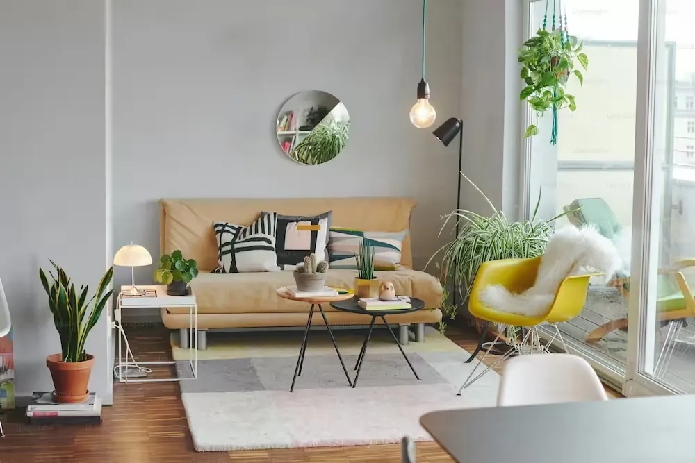 A brightly lit room with a sofa and other furnishings.